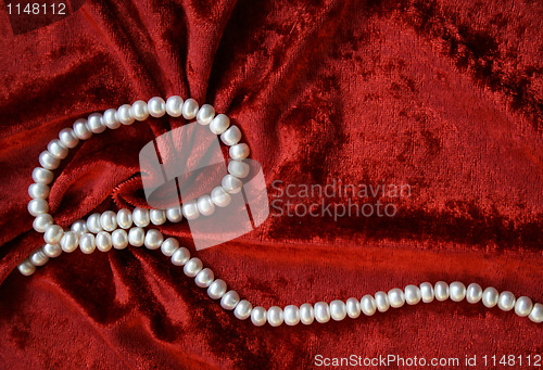 Image of Necklace of white pearls on a terracotta velvet 