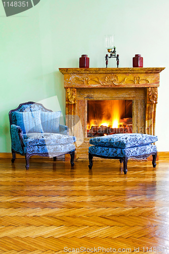 Image of Blue armchair fireplace