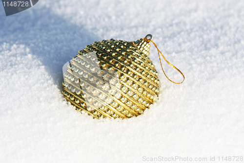 Image of golden christmas bauble in snow