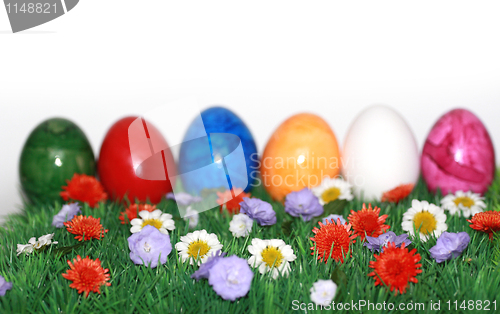 Image of Colorful Easter eggs on a flower meadow 