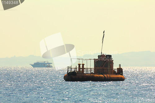 Image of abandoned rusty ship at anchor