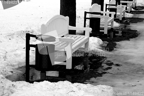 Image of white bench in the park in winter time