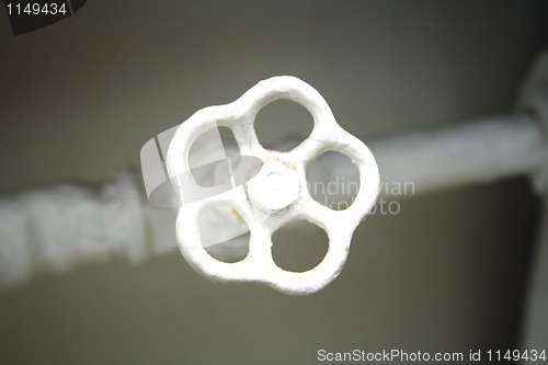 Image of old white radiator valve close up