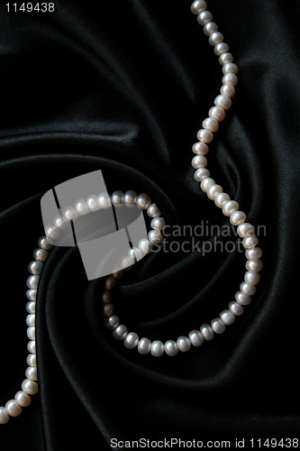 Image of White pearls on the black velvet background 