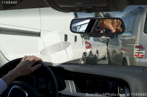 Image of Young female driver in heavy traffic