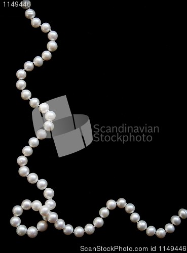 Image of White pearls on the black silk 