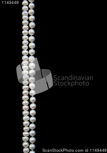 Image of White pearls on the black silk