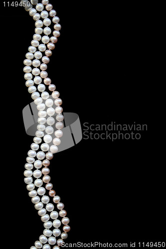 Image of White and pink pearls on the black silk 