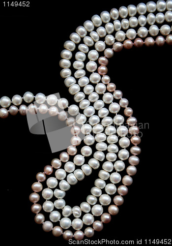 Image of White and pink pearls on the black silk 