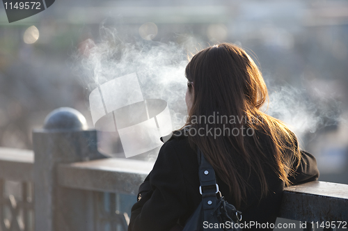 Image of Smoking girl on bridge