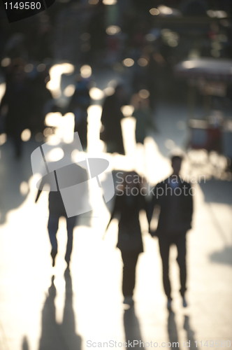 Image of Crowd of shoppers in sunlight