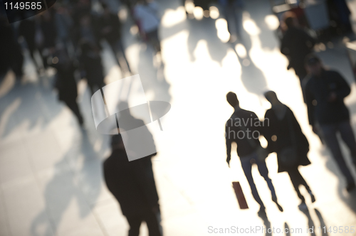 Image of Shoppers in evening light with couple