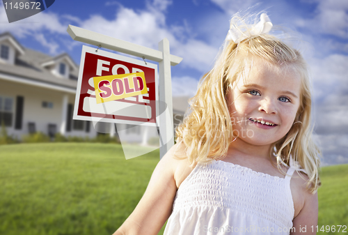Image of Cute Girl in Yard with Sold For Sale Real Estate Sign and House