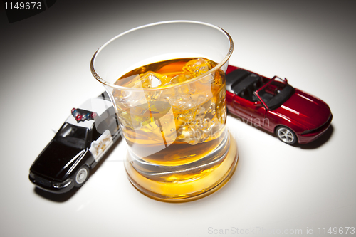 Image of Police and Sports Car Next to Alcoholic Drink