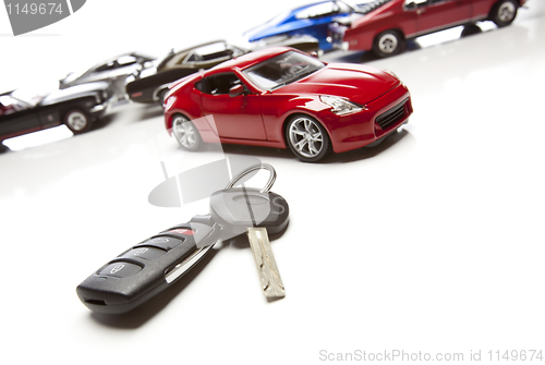 Image of Car Keys and Several Sports Cars on White