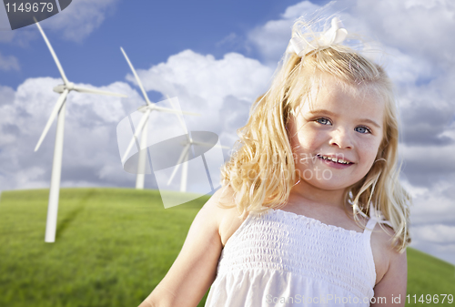 Image of Beautiful Young Girl Playing in Wind Turbine Field