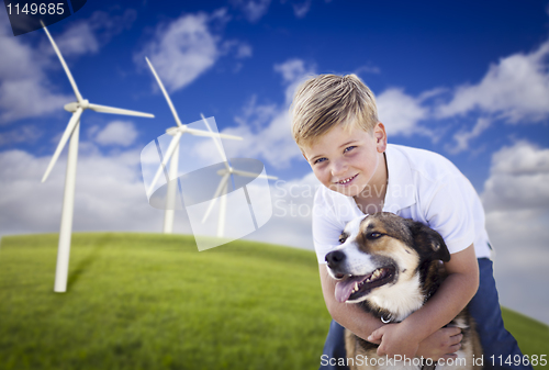 Image of Young Boy and Dog in Wind Turbine Field