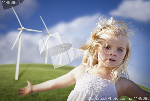 Image of Beautiful Young Girl Playing in Wind Turbine Field