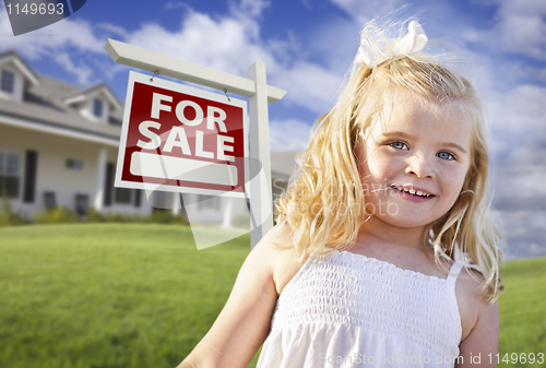 Image of Cute Smiling Girl in Yard with For Sale Real Estate Sign and Hou