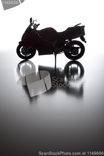 Image of Silhouette of Street Motorcycle on Reflective Surface 