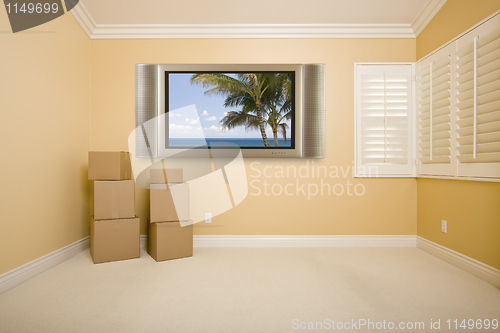 Image of Flat Panel Television on Wall in Empty Room with Boxes