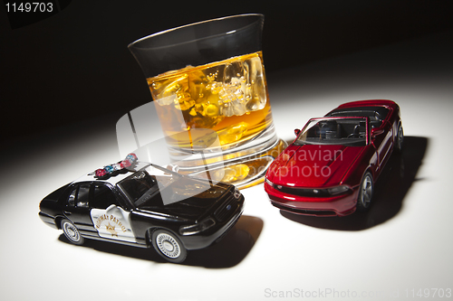 Image of Police and Sports Car Next to Alcoholic Drink