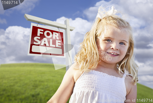 Image of Smiling Cute Girl in Field with For Sale Real Estate Sign