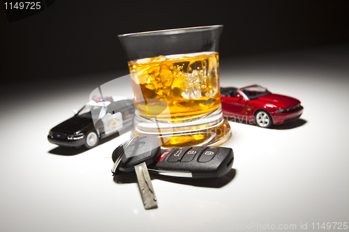 Image of Highway Patrol Police and Sports Car Next to Alcoholic Drink and