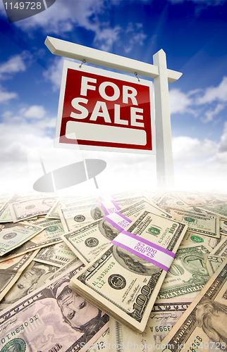 Image of Stacks of Money and For Sale Real Estate Sign