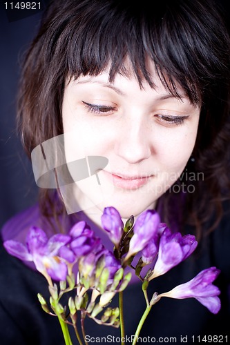 Image of woman with purple flower