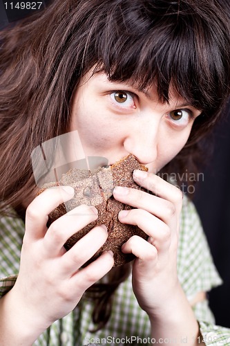 Image of beggar woman eating bread 