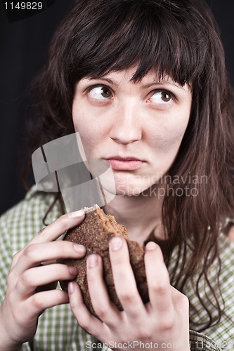 Image of beggar woman with a piece of bread