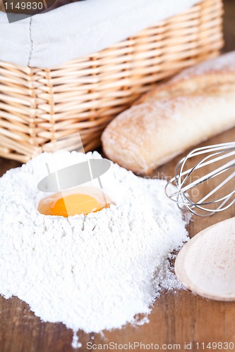 Image of bread, eggs, whisk and flour