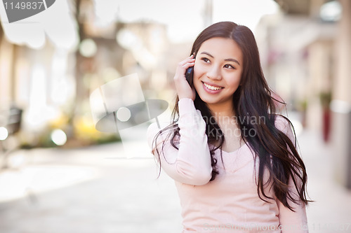 Image of Asian woman on the phone