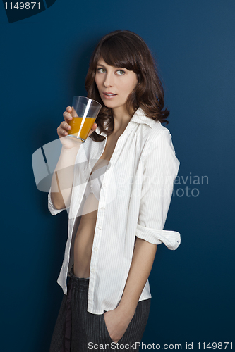 Image of Beautiful woman drinking orange juice