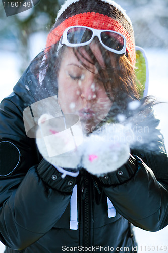 Image of Woman blowing snow