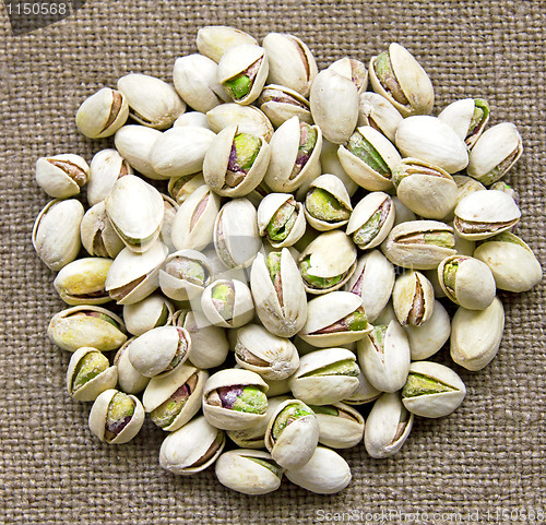 Image of Delicious pistachios on sackcloth background
