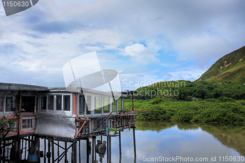 Image of wood house on the water