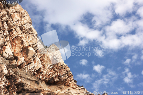 Image of Big rock under blue clouded sky
