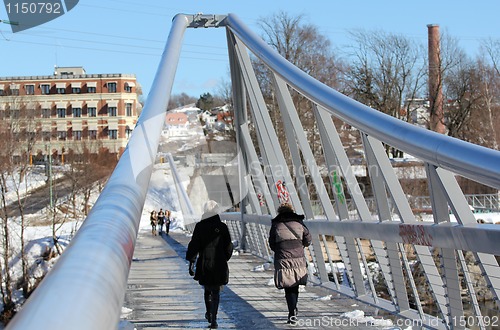 Image of People walking on the bridge.