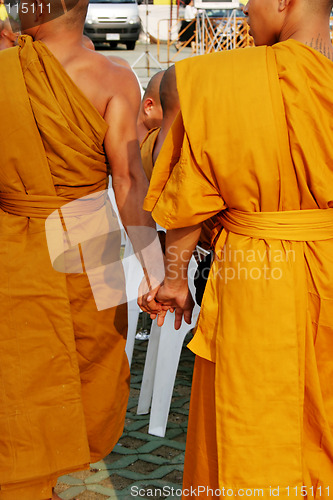 Image of Monks holding hands