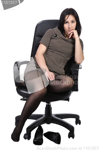 Image of Girl in brown dress in an office chair, isolated