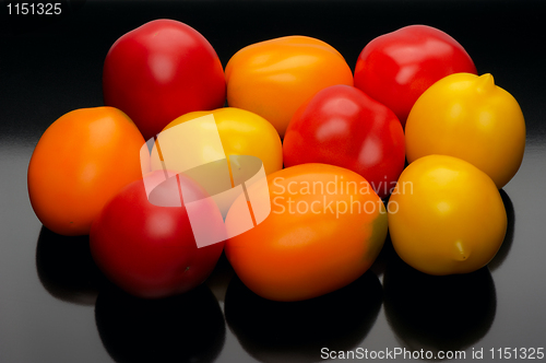 Image of Multicolored tomatoes on a black backgrouns