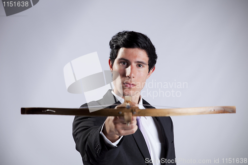 Image of Businessman aiming with a Crossbow