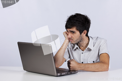 Image of Young working with his laptop