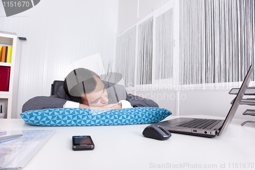 Image of Businessman sleeping at the office