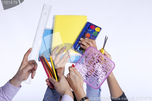 Image of Hands holding education objects