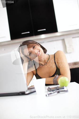 Image of Modern woman reading e-mails at her breakfast