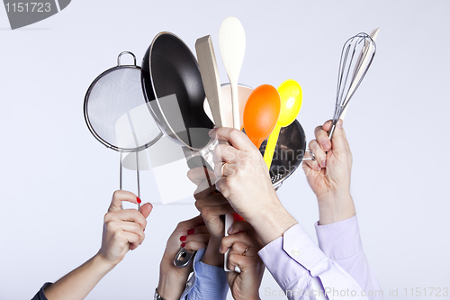 Image of Hands holding kitchenware tools