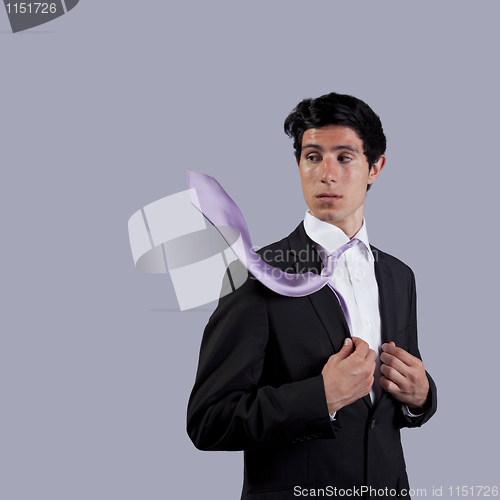 Image of Businessman looking to his flying necktie